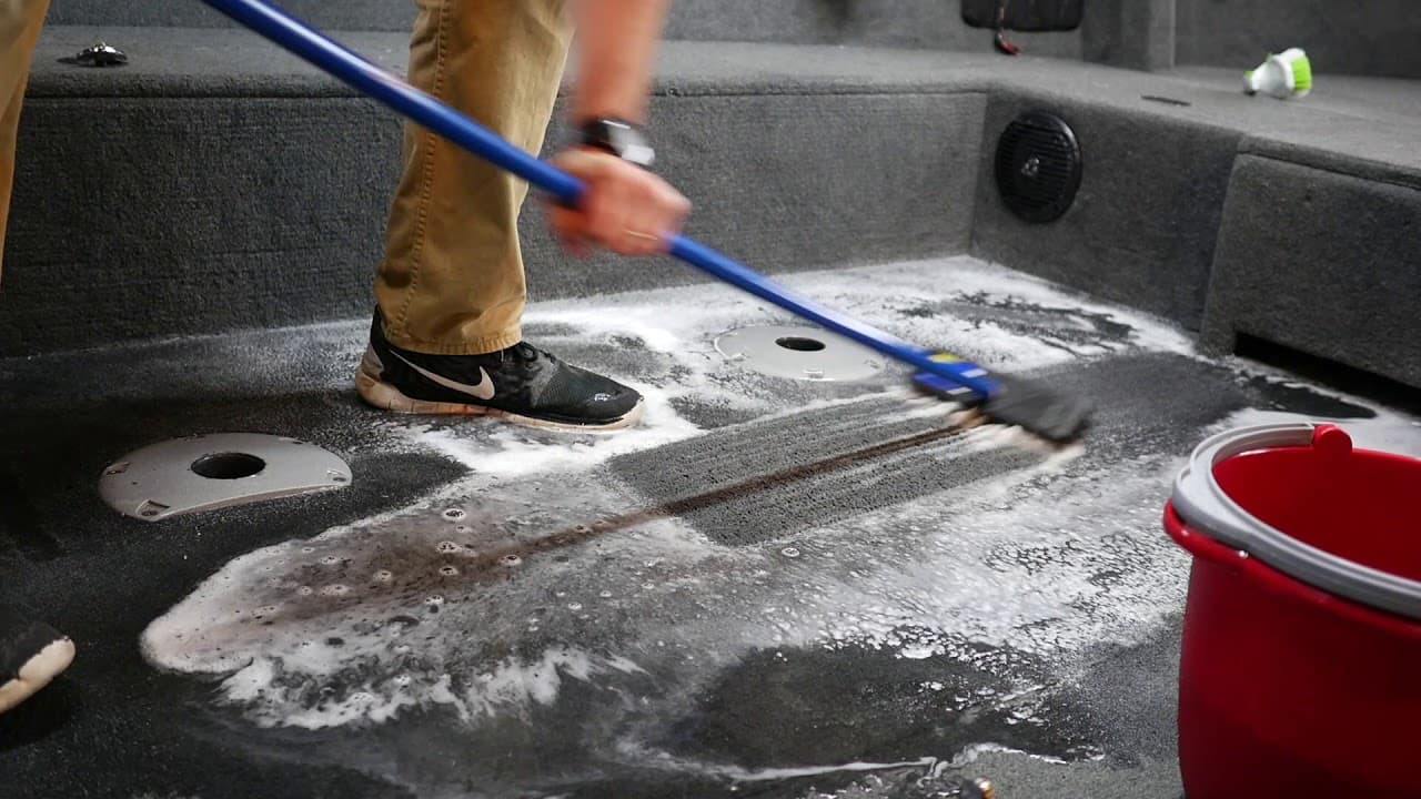 employee cleaning the interior of a customers boat